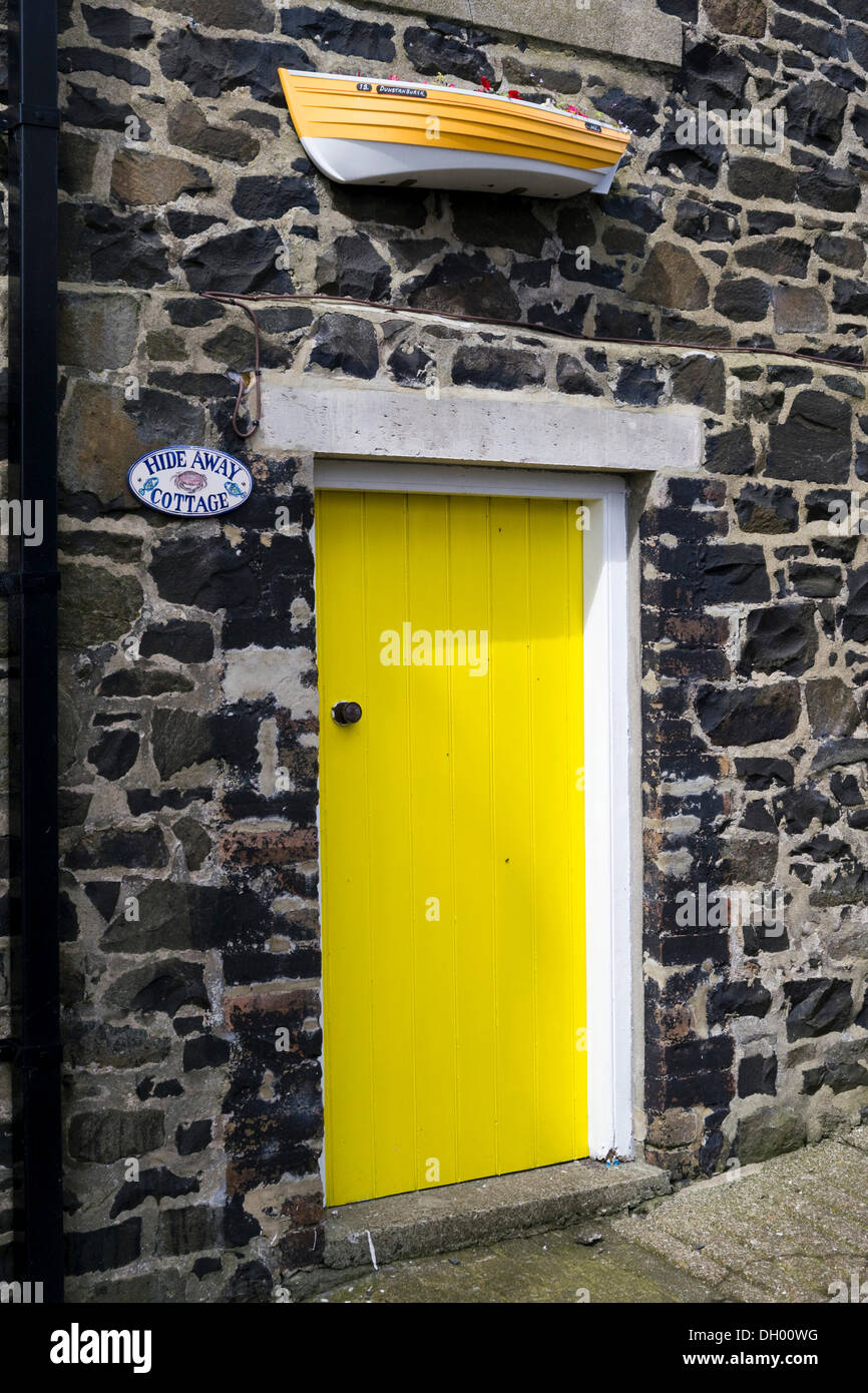 Yellow door of a cottage on the coast, Northumberland, England, United Kingdom Stock Photo