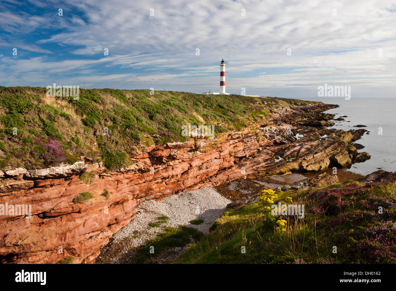 Red cliffs and lighthouse, Tarbat Ness, Scotland, United Kingdom Stock Photo
