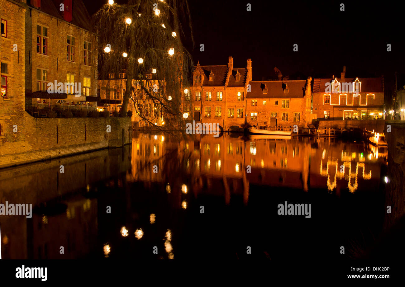 Canalside buildings in Bruges by night, with illuminations, Belgium. Stock Photo