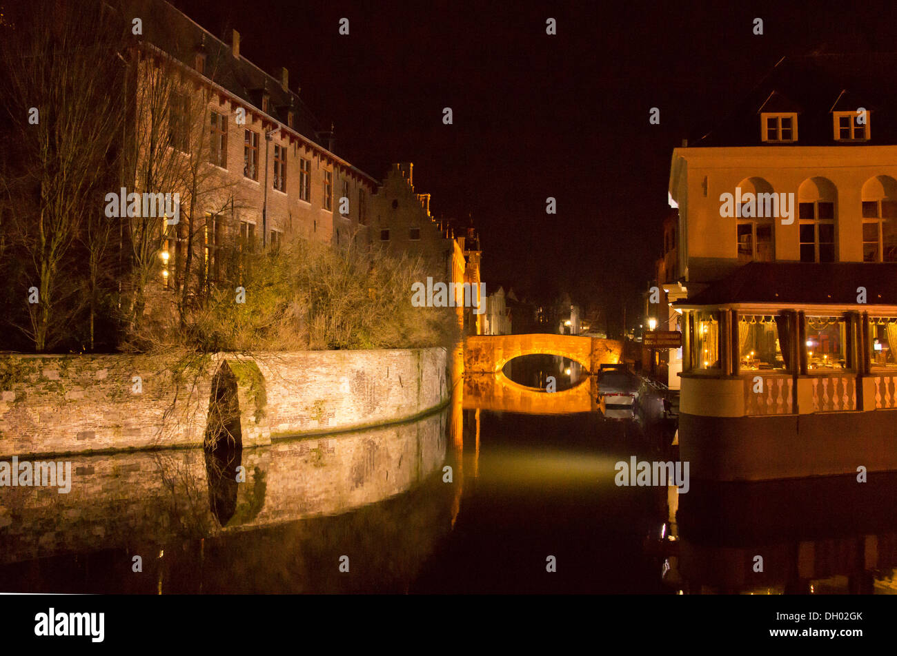 Canalside buildings in Bruges by night, Belgium. Stock Photo