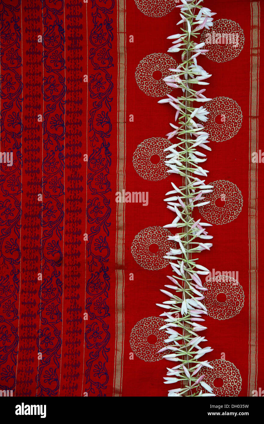 Closed Jasmine flower garland on a colourful Indian sari Stock Photo