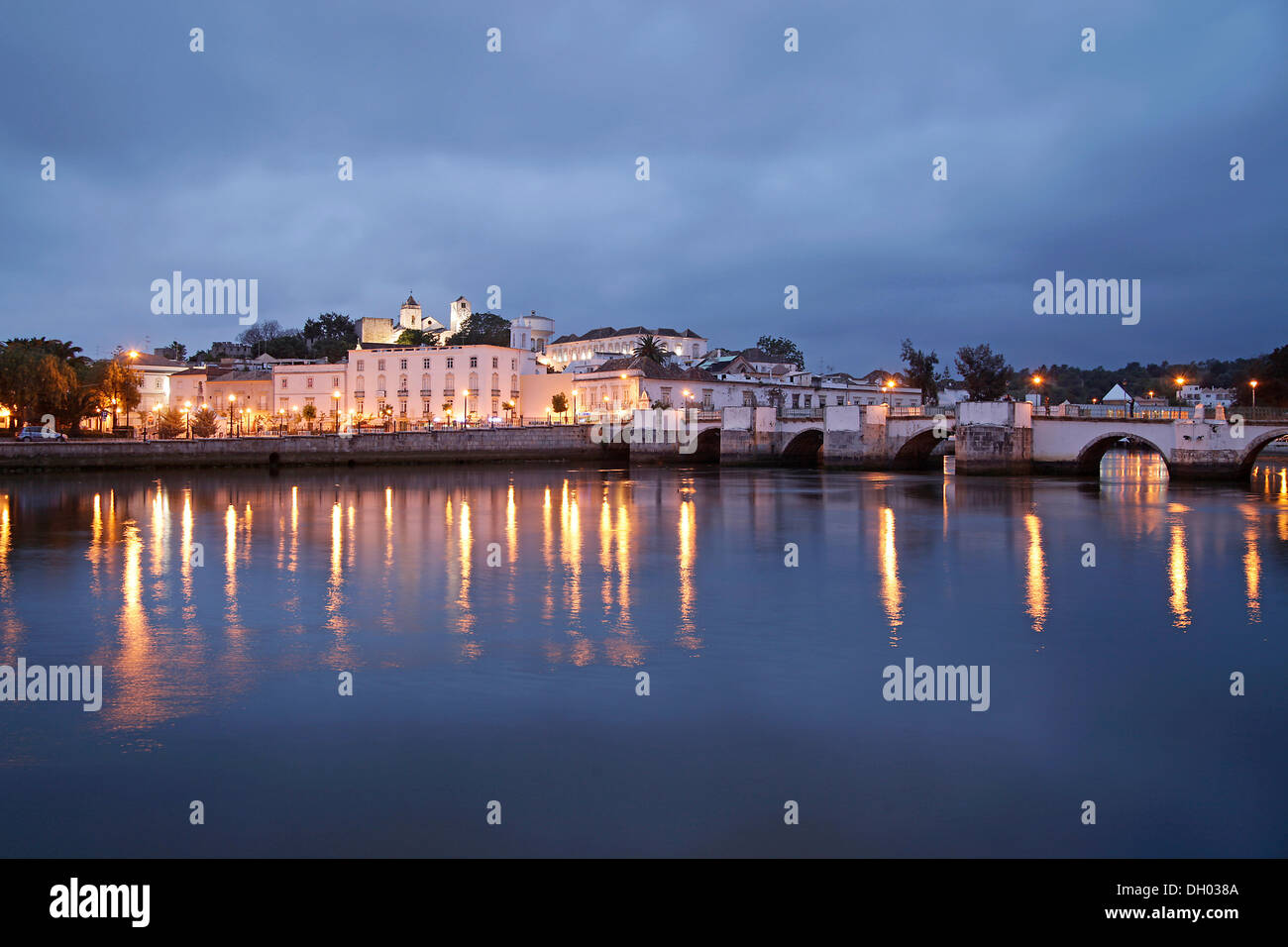 The lights of the old town and the Roman bridge are reflected in the Gilao river, Tavira, Algarve, Portugal, Europe Stock Photo