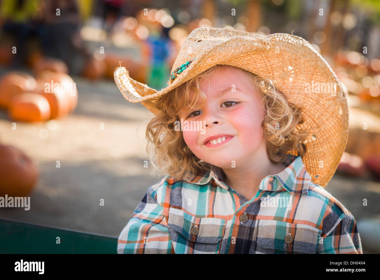 Adorable Little Boy Wearing Cowboy Hat at Pumpkin Patch Farm. Stock Photo