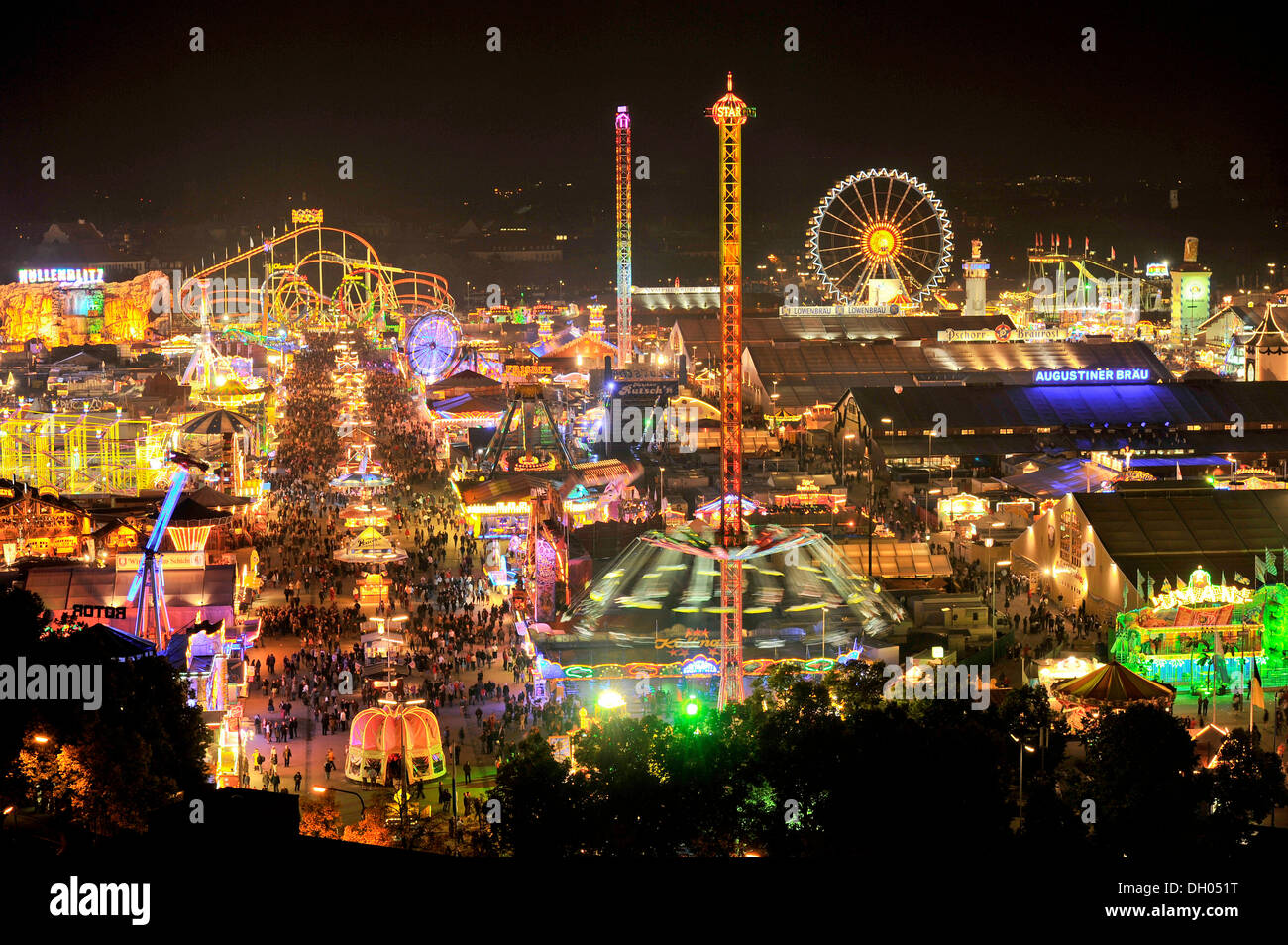 View of the Oktoberfest festival at night, with illuminated stalls