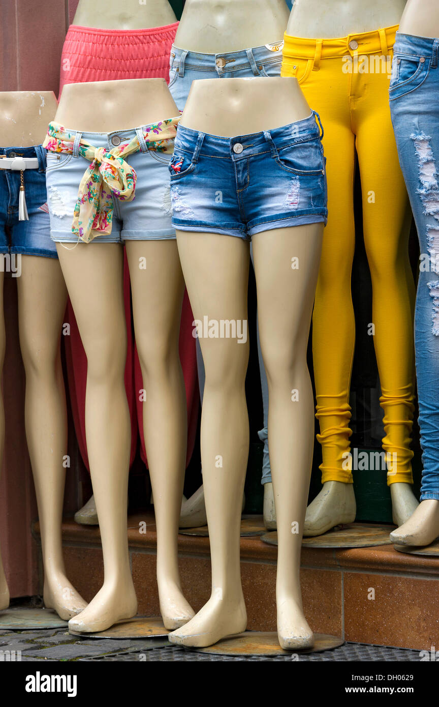 Legs of mannequins with jeans and hot pants, in front of a fashion shop, Büdingen, Hesse, Germany Stock Photo