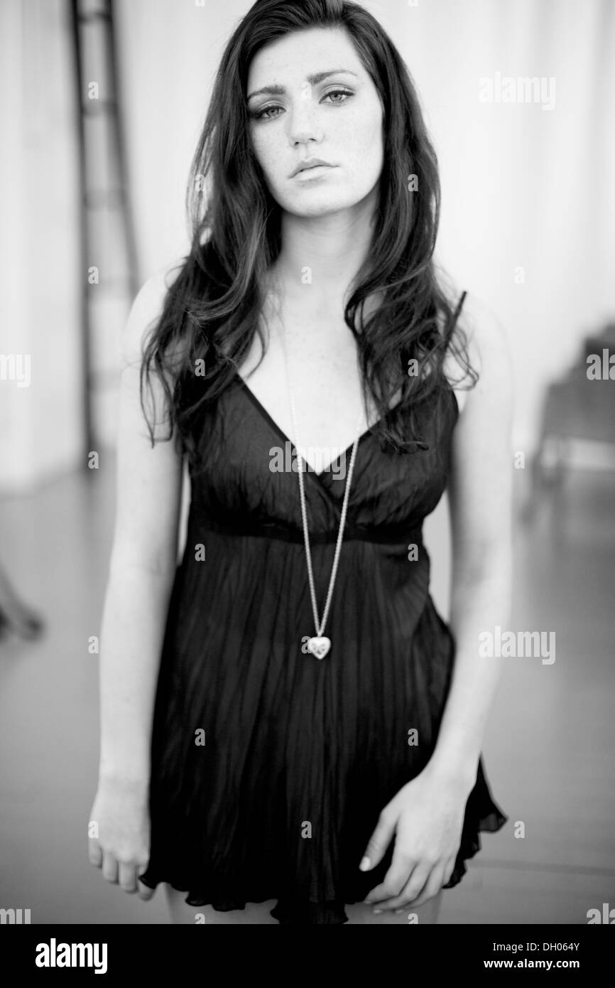 Petulant naughty girl in black silk baby doll dress pouts at your no doubt  lewd request. No way, buster, not happening Stock Photo - Alamy