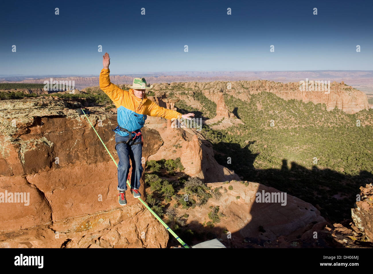 Man highlining, slacklining, between Navaho Sandstone Towers on BLM land near Moab, Utah, USA Stock Photo
