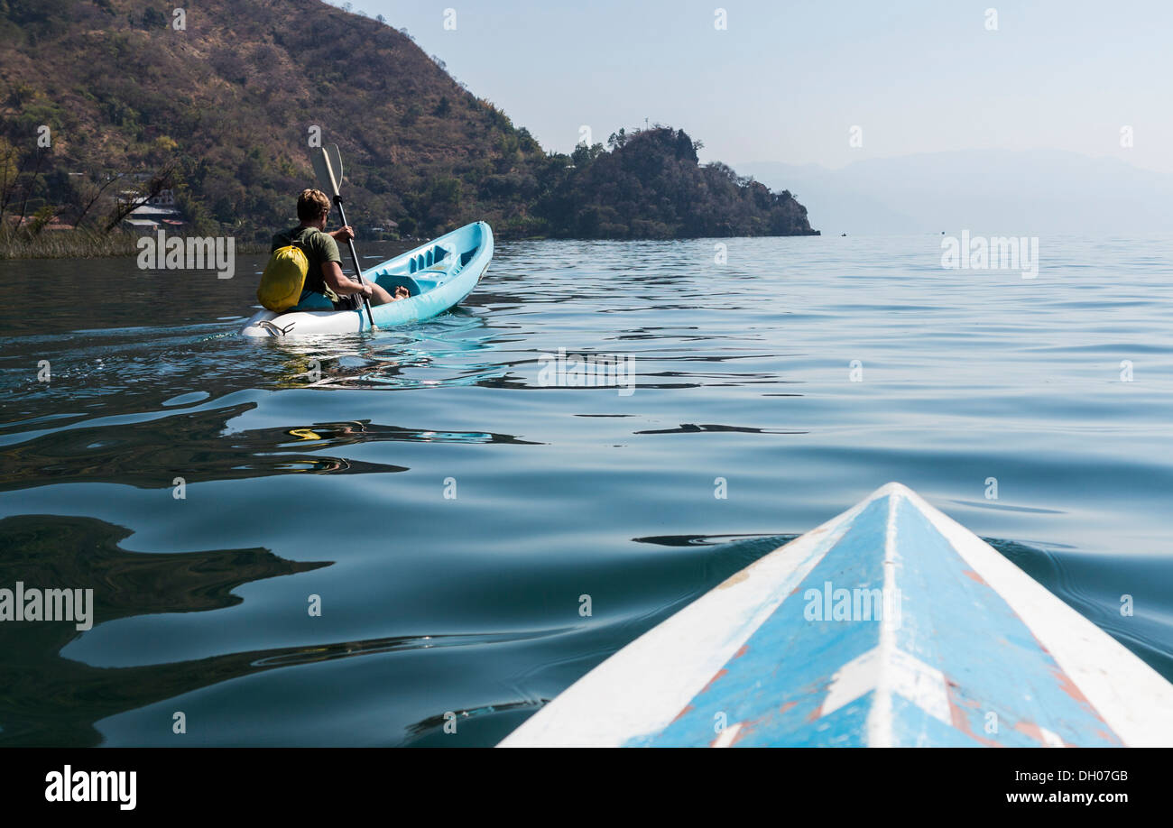 Man paddling in canoe on Lake Atitlan in Guatemala Stock Photo