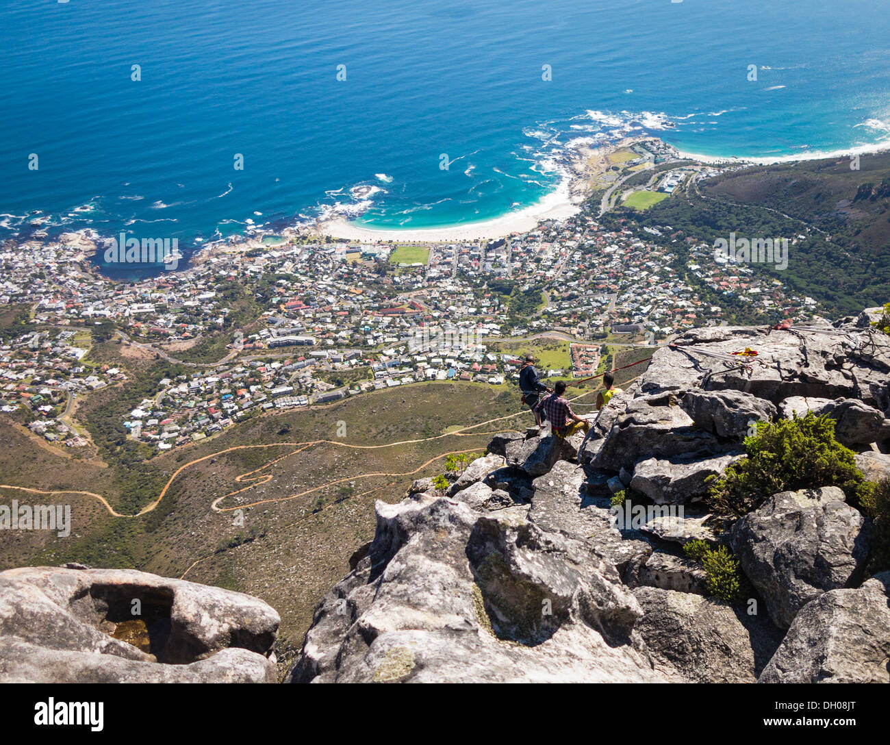 Cape Town from Table Mountain in South Africa - with people abseiling down the side Stock Photo