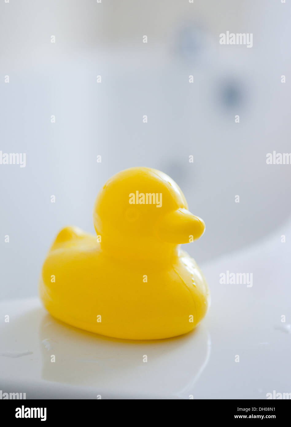 yellow rubber duck on side of bath Stock Photo - Alamy