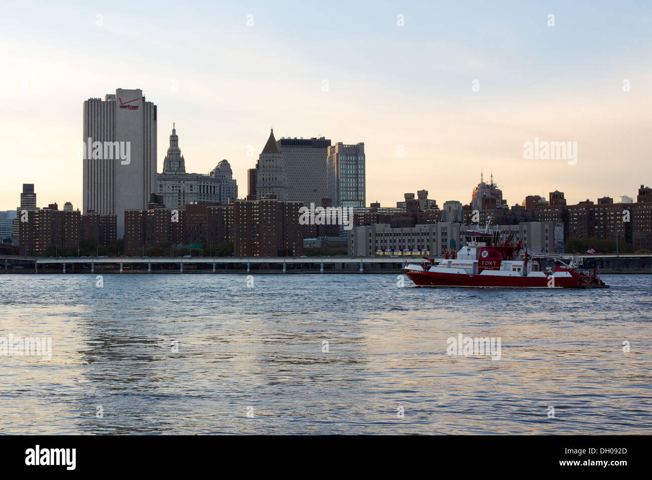 Lower East Side neighborhood of Two Bridges at dusk with an FDNY boat