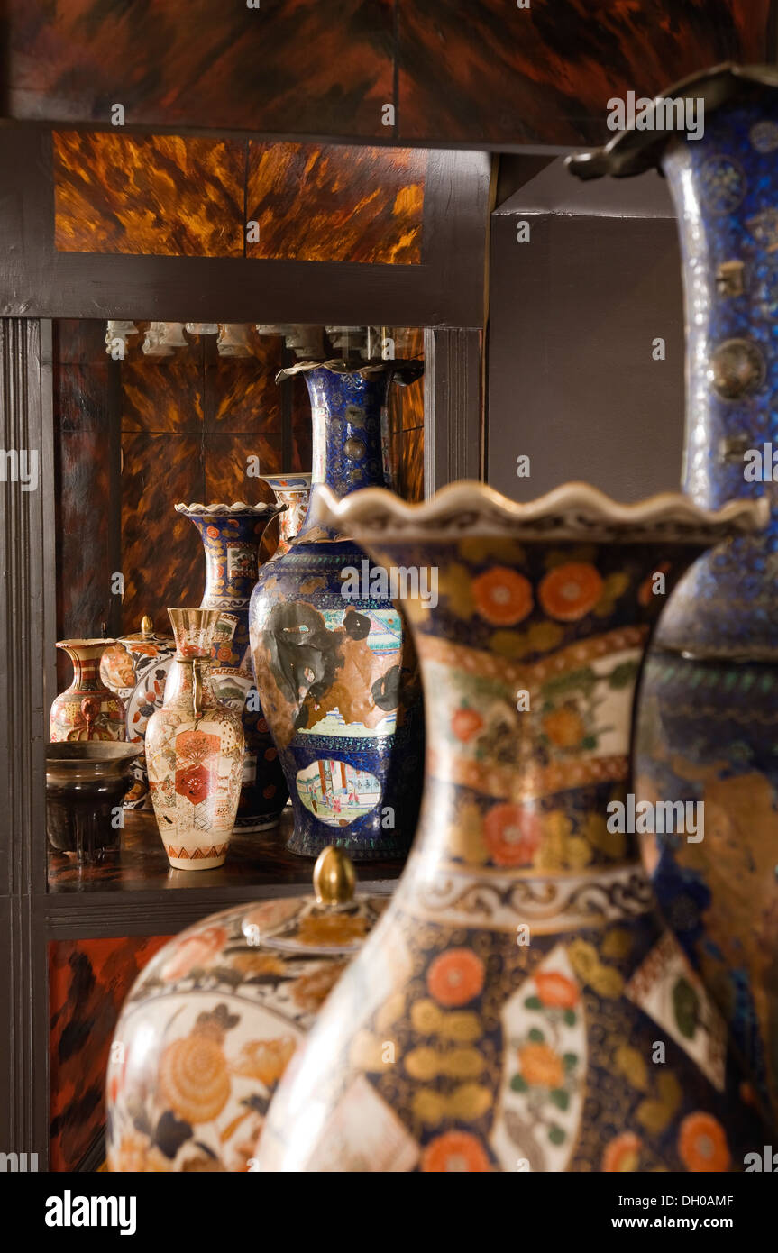Cabinet collection of decorative metal vases found at Bonhams Auction house in London Stock Photo