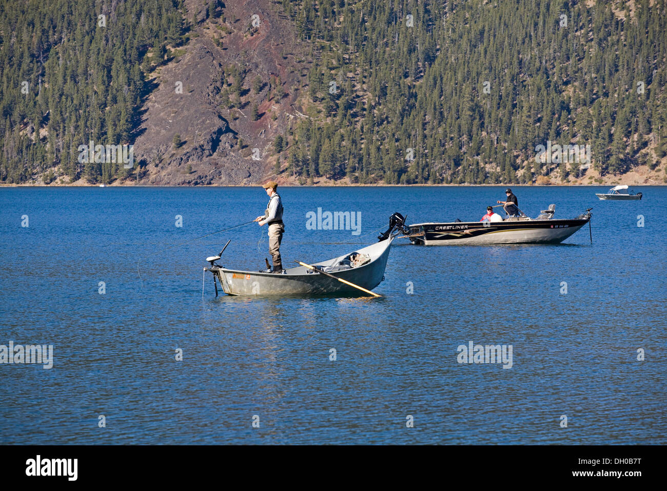 A fly fisherman on East lake, in Central Oregon, fishing for rainbow trout Stock Photo