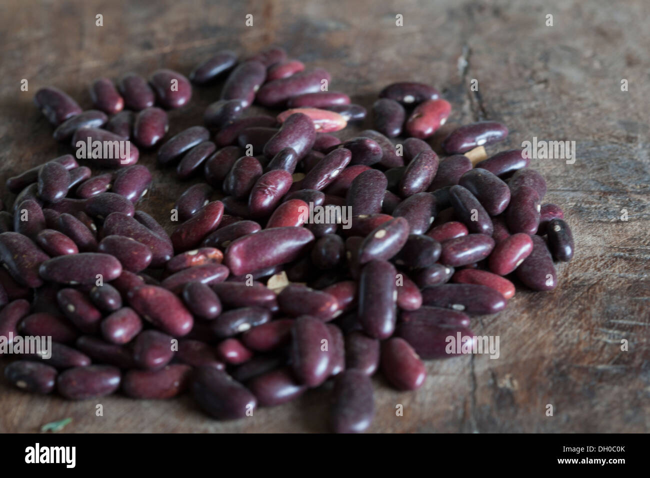 Dried red kidney beans on dark wooden board Stock Photo