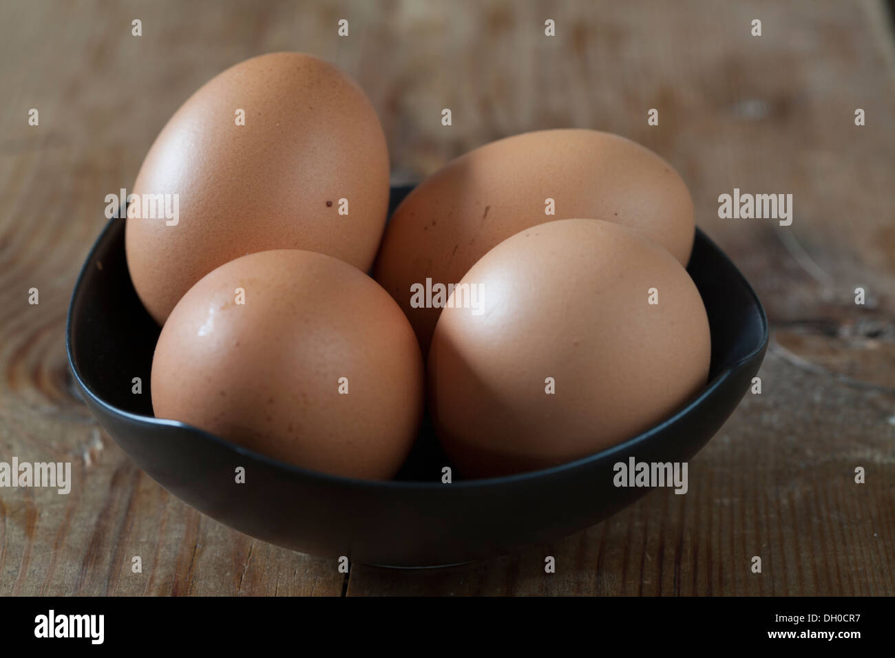 Chicken eggs in black bowl Stock Photo