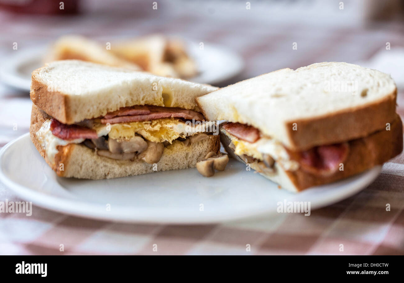 A halved bacon, egg and mushroom sandwich on a plate, London, England, UK Stock Photo Alamy