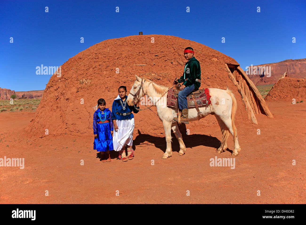 Navajo Indian family with a horse, in front of a Navajo Hogan, a traditional residence, Monument Valley, Utah, United States Stock Photo