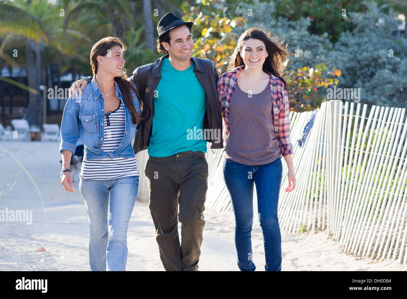 Friends walking on beach Stock Photo