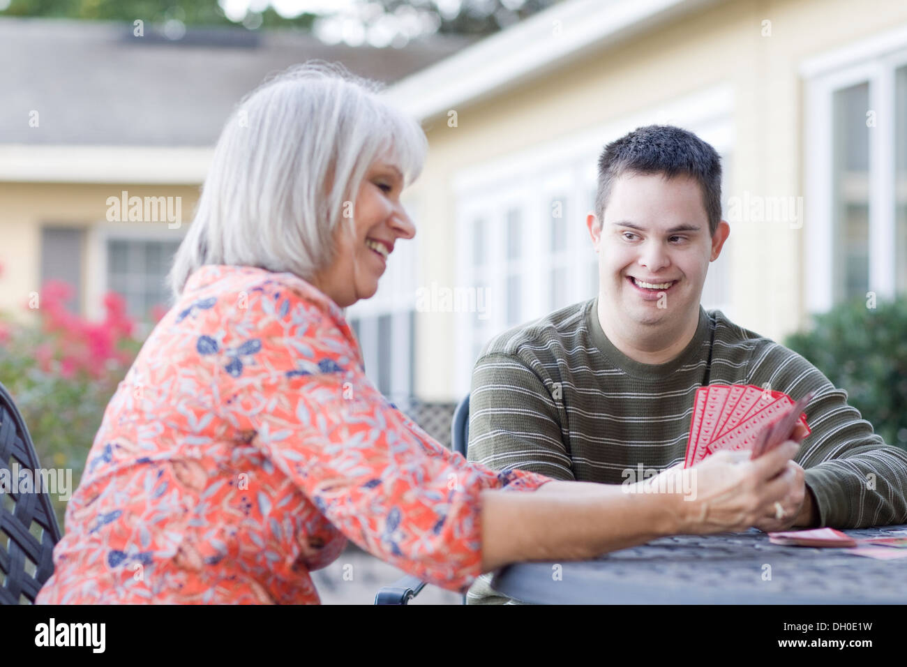 Caucasian mother and disabled son playing cards Stock Photo