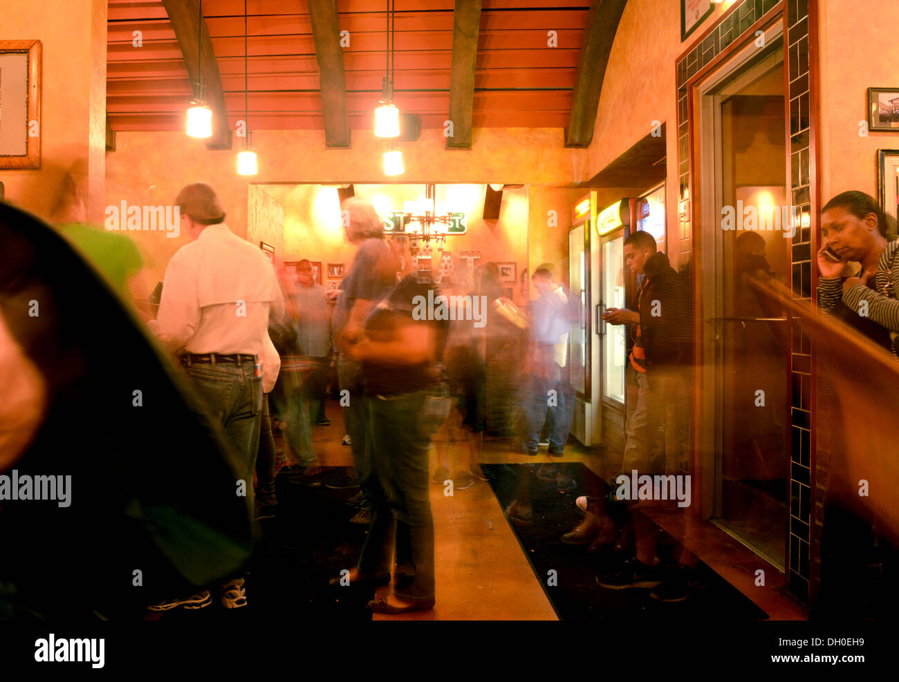 Busy take out restaurant. Lou Malnatis Deep Dish Pizza in Chicago, customers blur as they come and go Stock Photo