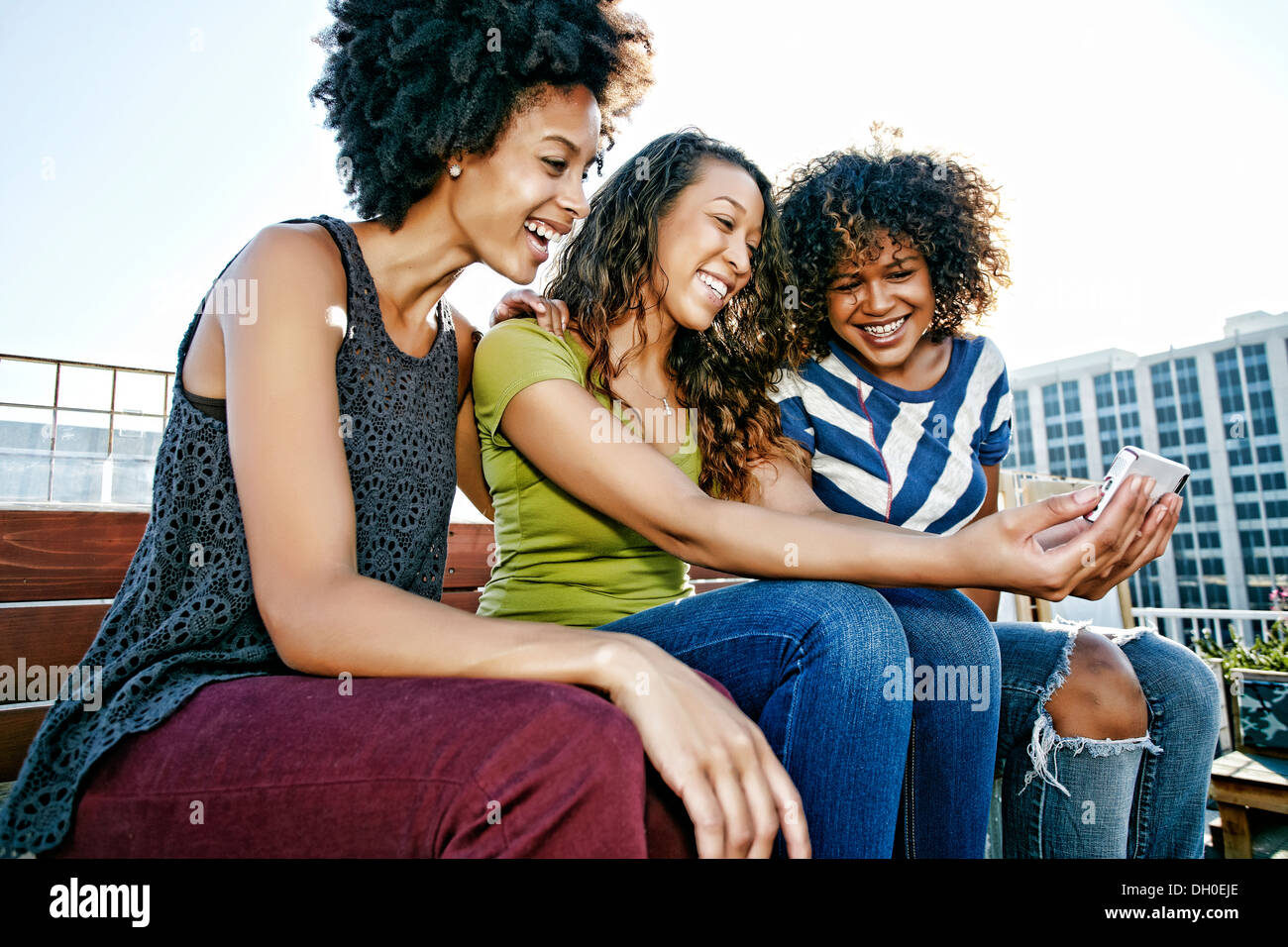 Women taking self-portrait on urban rooftop Stock Photo