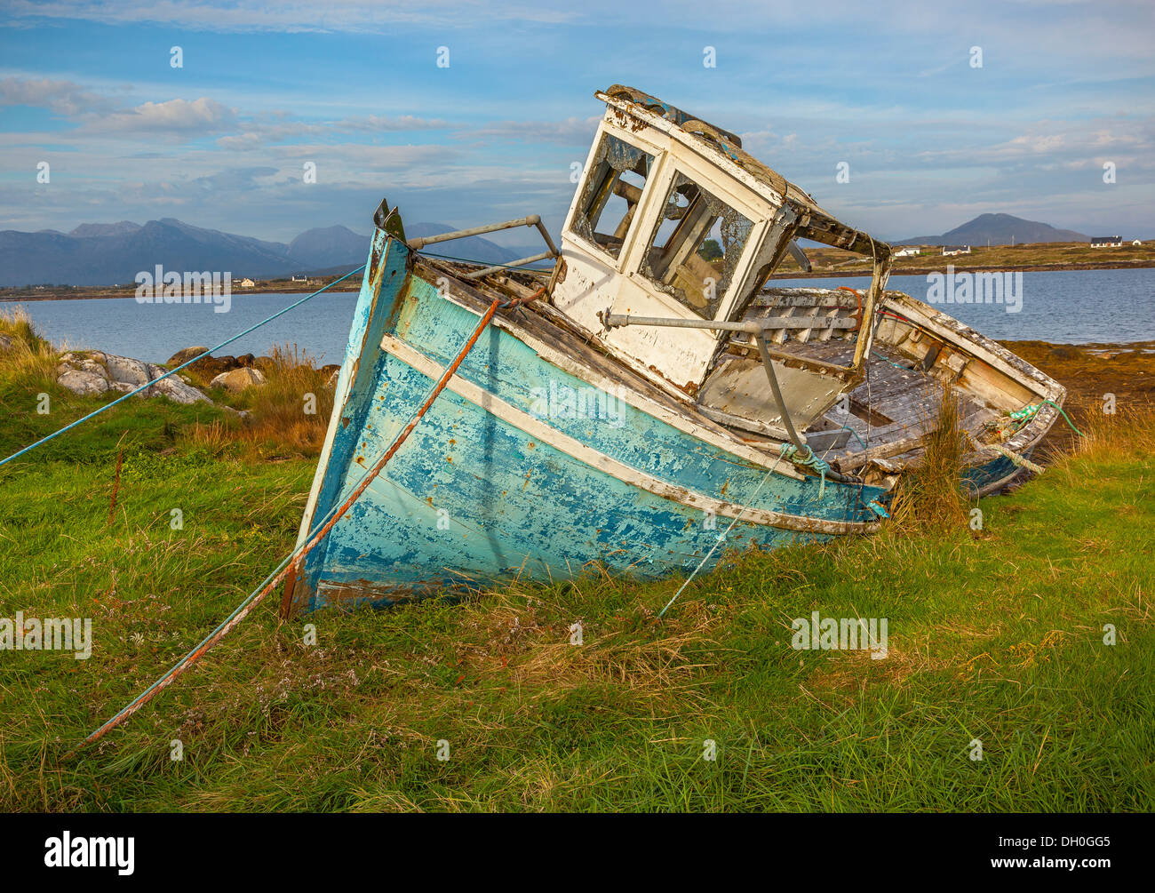 County Galway, Ireland: Weathered blue fishing boat near the shoreline of Bertraghboy Bay in the village of Roundstone Stock Photo