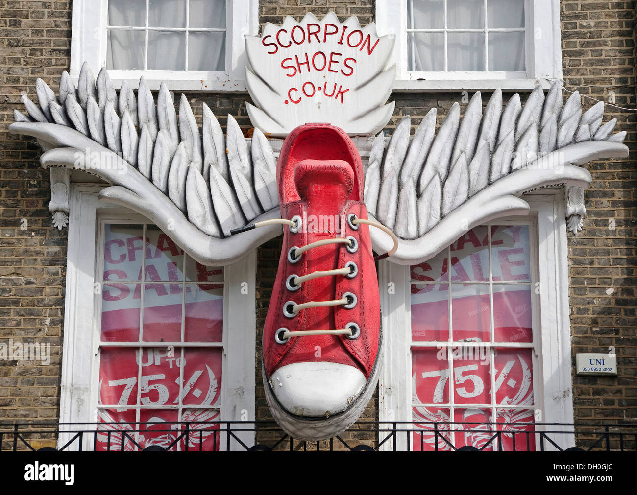 scorpion shoes, larger than life, red trainer shoe's, with wings, attached, to the side of shop front, building, Stock Photo