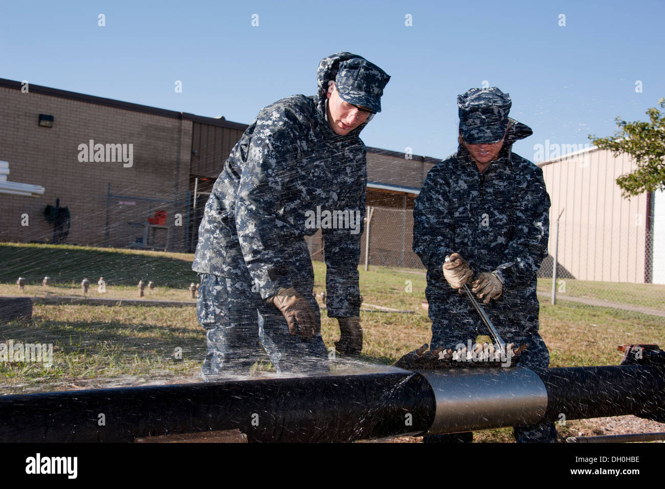 U.S. Navy Seaman Daniel Dunn and Seaman Recruit Victoria Vento, 366 Training Squadron students, perform emergency repairs to a water main in the Water and Fuel Systems Maintenance Apprentice course at Sheppard Air Force Base, Texas, Oct.22. Students learn Stock Photo