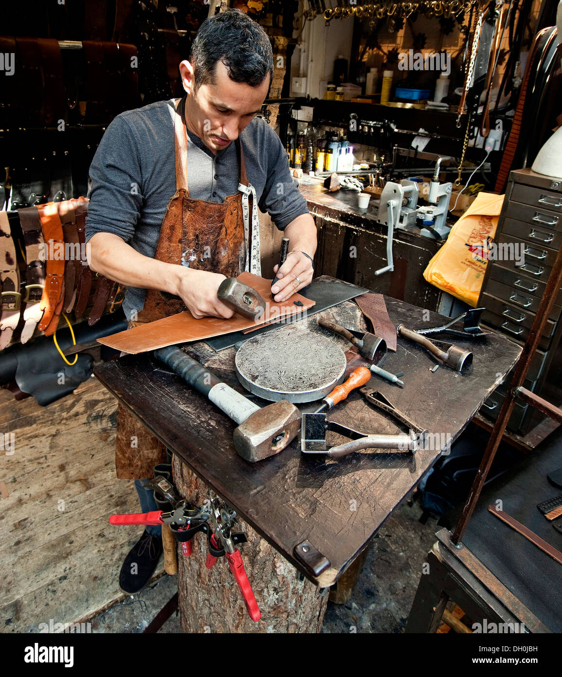 leather worker,Man crafting leather, hand made, leather goods Stock