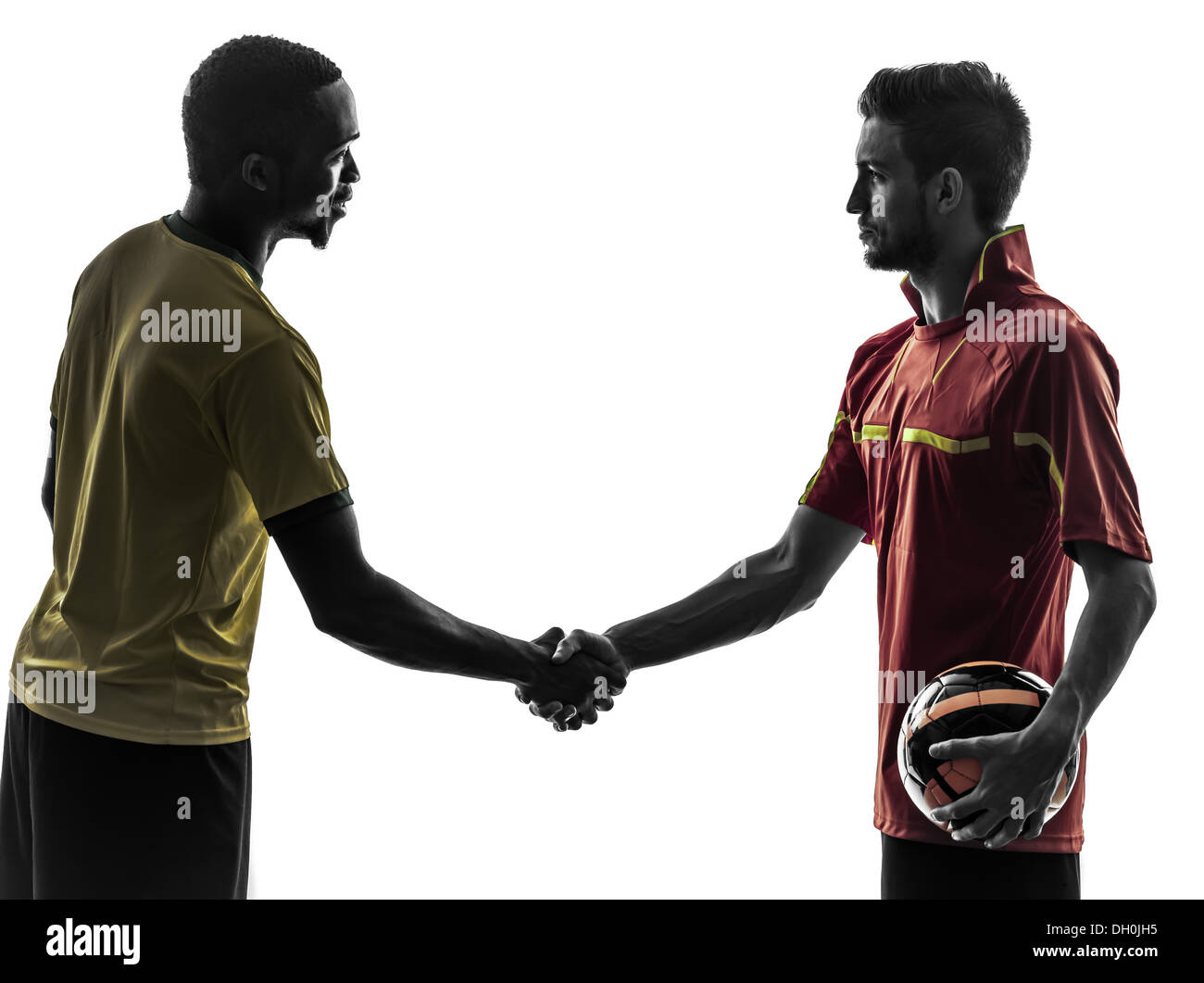two men soccer player playing football competition handshake handshaking in silhouette on white background Stock Photo