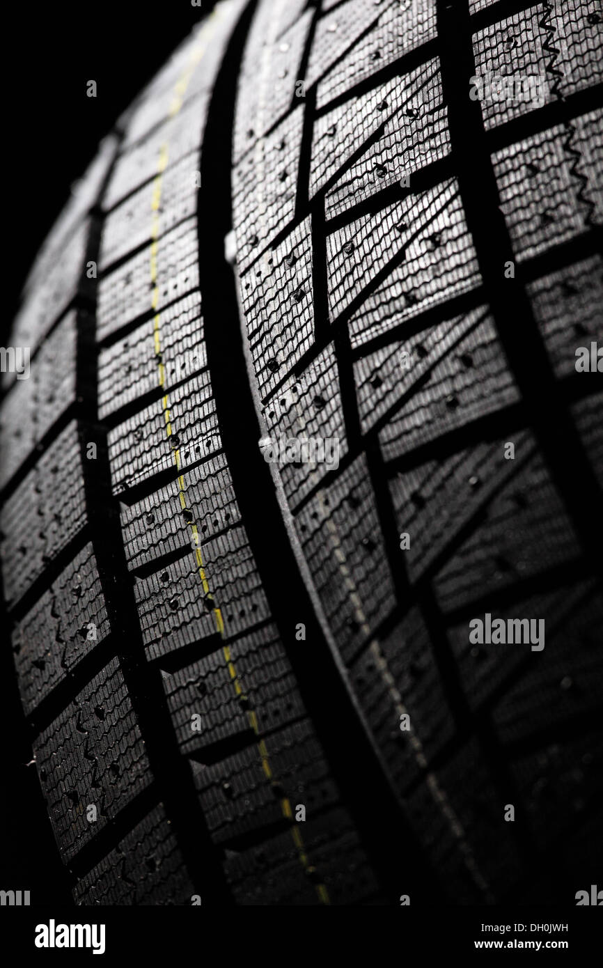 Winter tire tread. Part of modern winter vehicle wheel close-up. Stock Photo