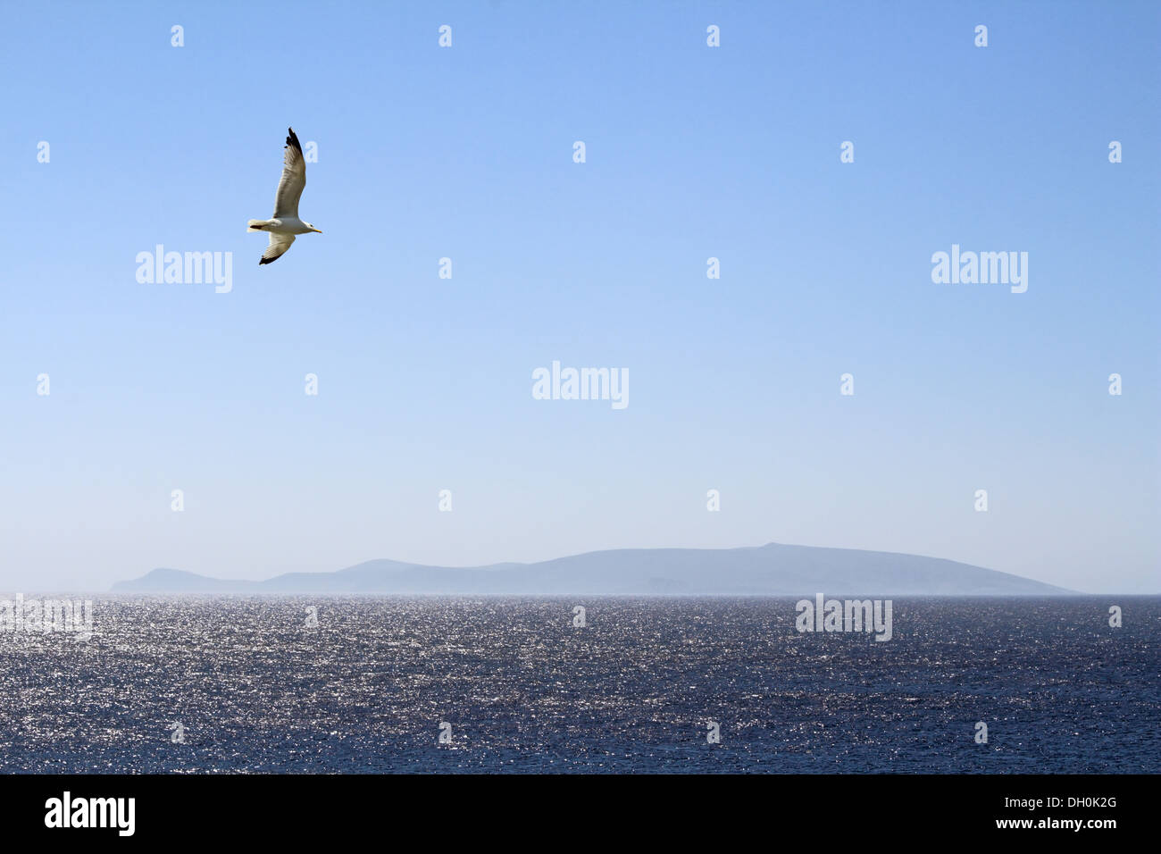 Looking to blue Aegean seascape, single island in the background Stock Photo