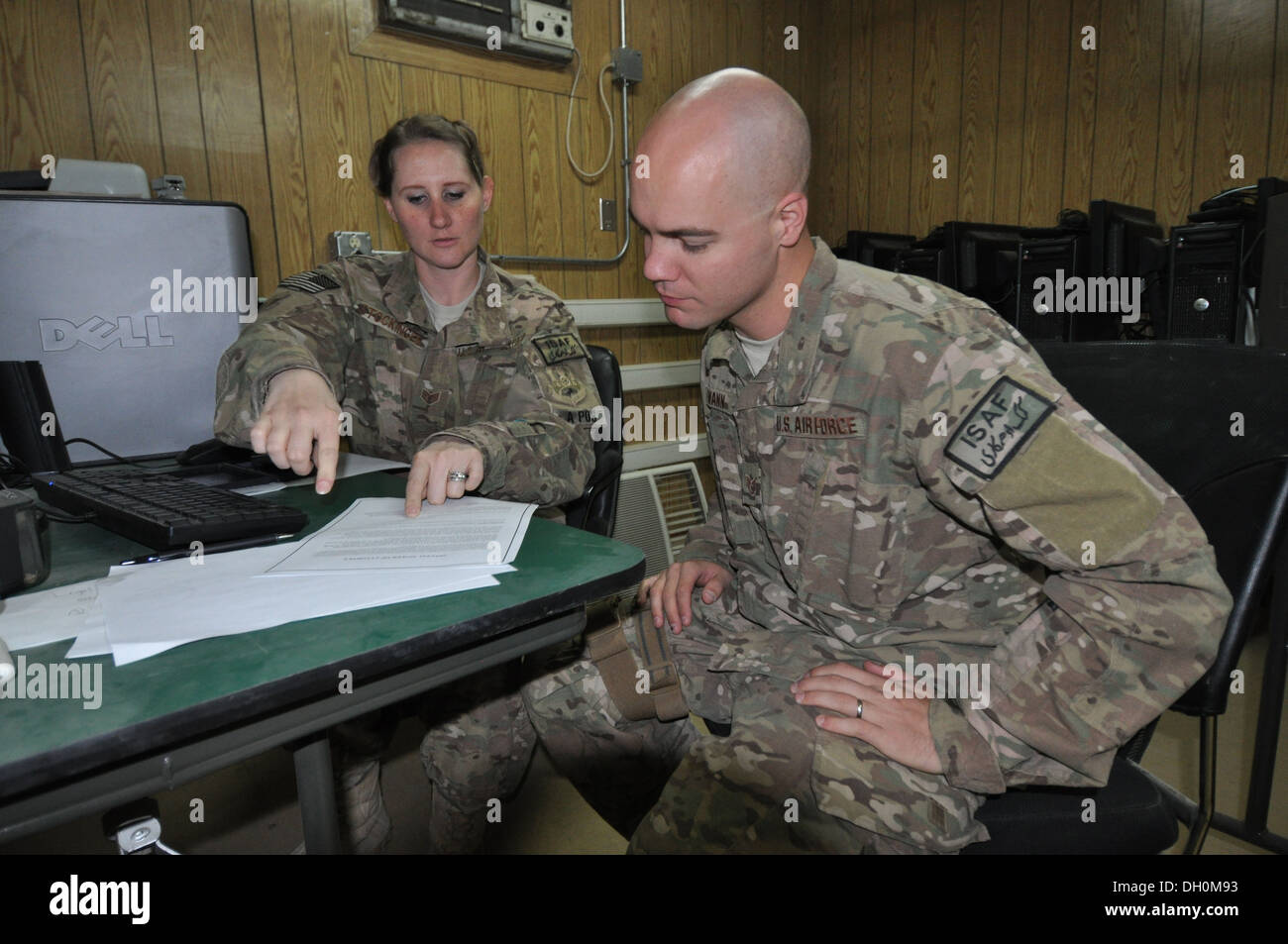 Staff Sgt. Megan Stockinger, 455th Air Expeditionary Wing NCO in charge of military justice, deployed from Little Rock Air Force Base, Ark., and a native of Geneva, Ala., provides legal assistance to Staff Sgt. Lowell Wann, 455 AEW chaplain assistant, dep Stock Photo