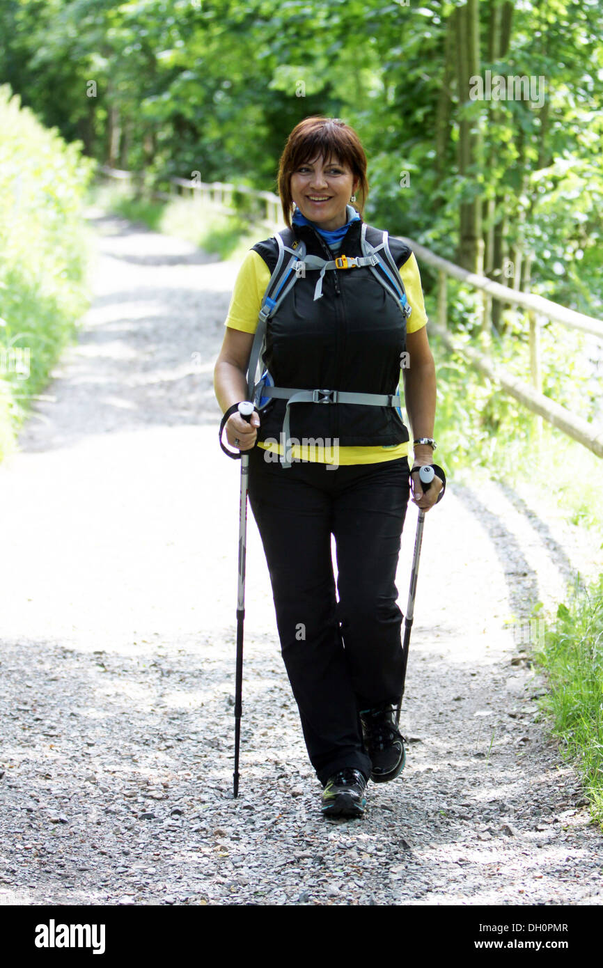 female hiker with hiking sticks Stock Photo