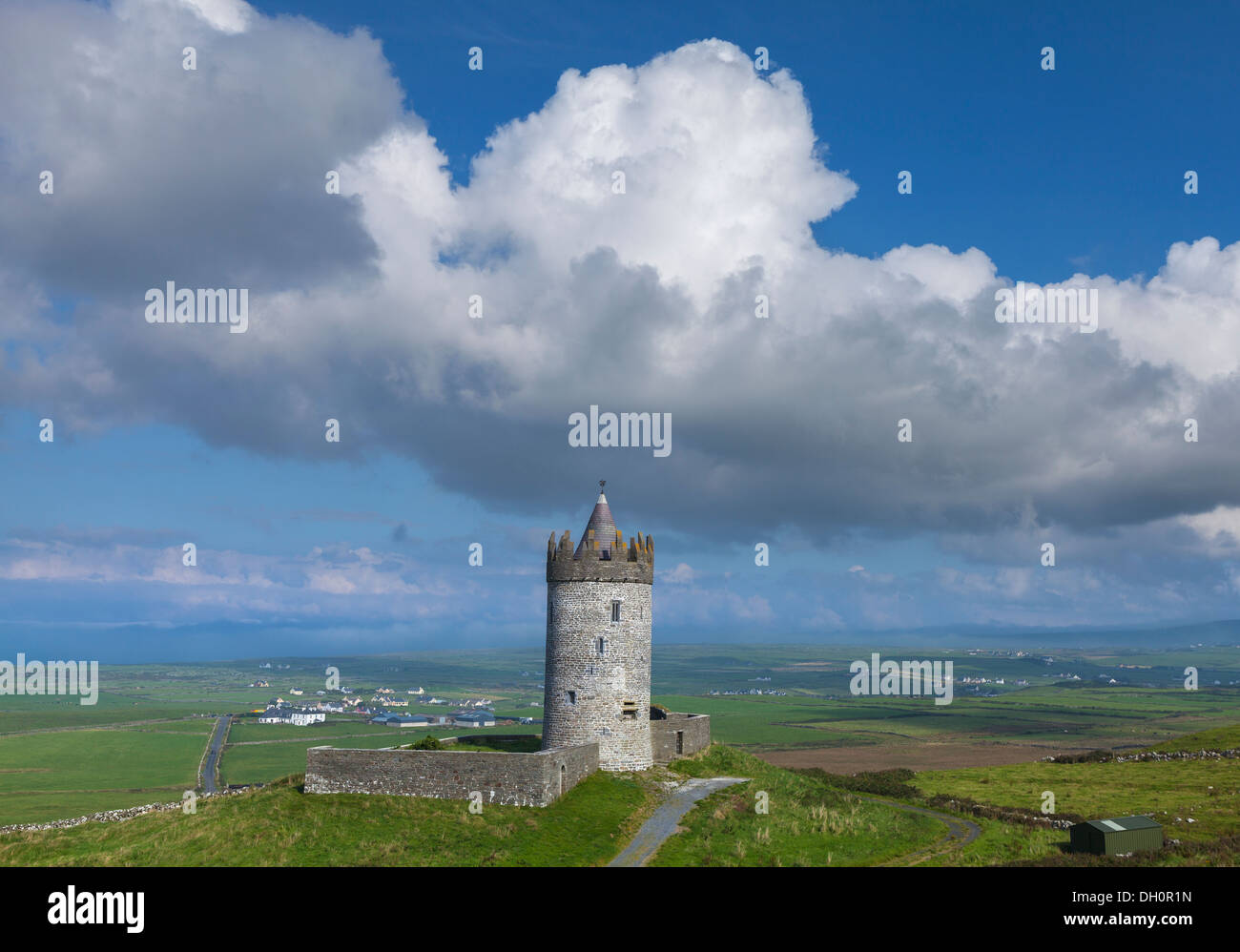 County Clare, Ireland: Round tower of Doonagore castle stands above the village of Doolin and the South Sound of Galway Bay Stock Photo