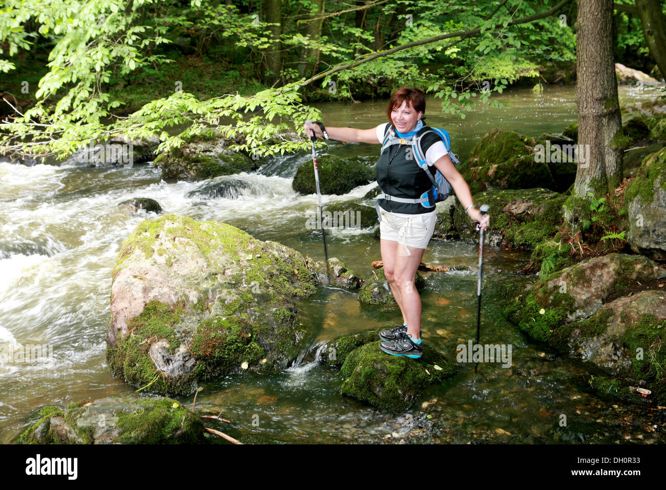 female walker with hiking sticks Stock Photo