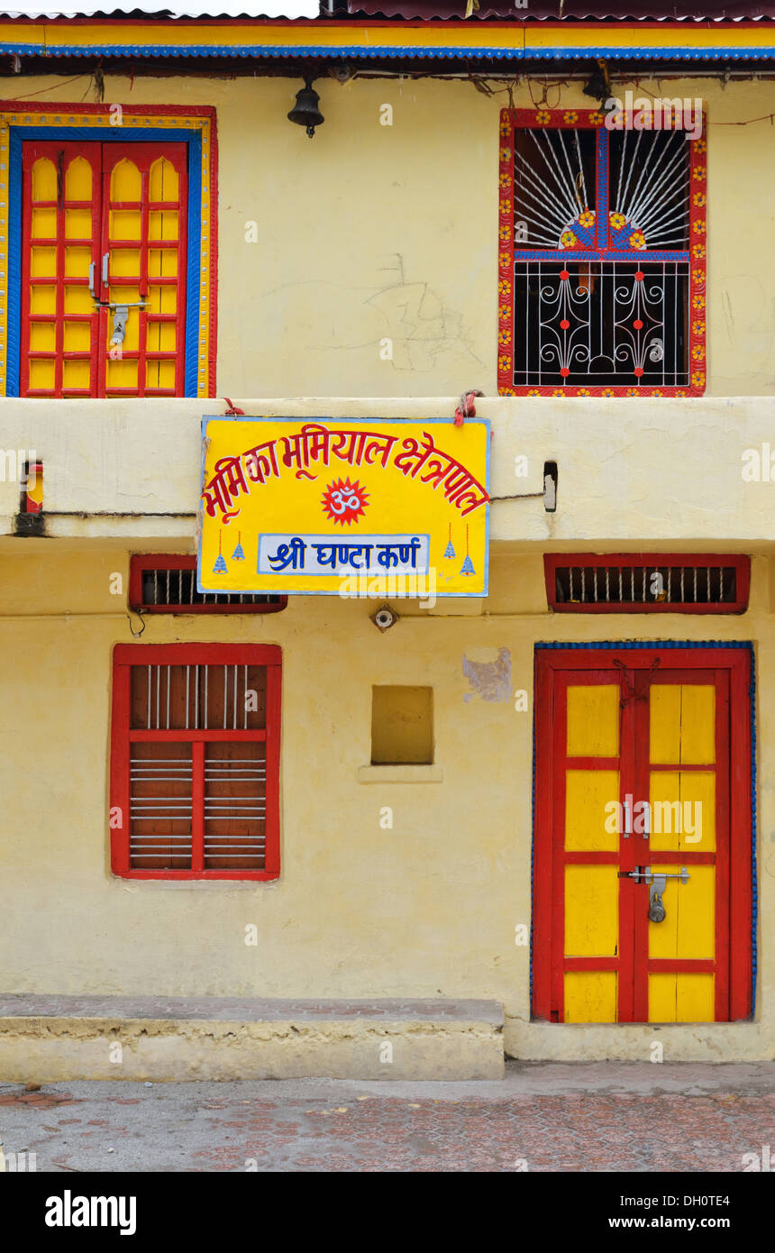 House with bright yellow sign in Mana village, India Stock Photo