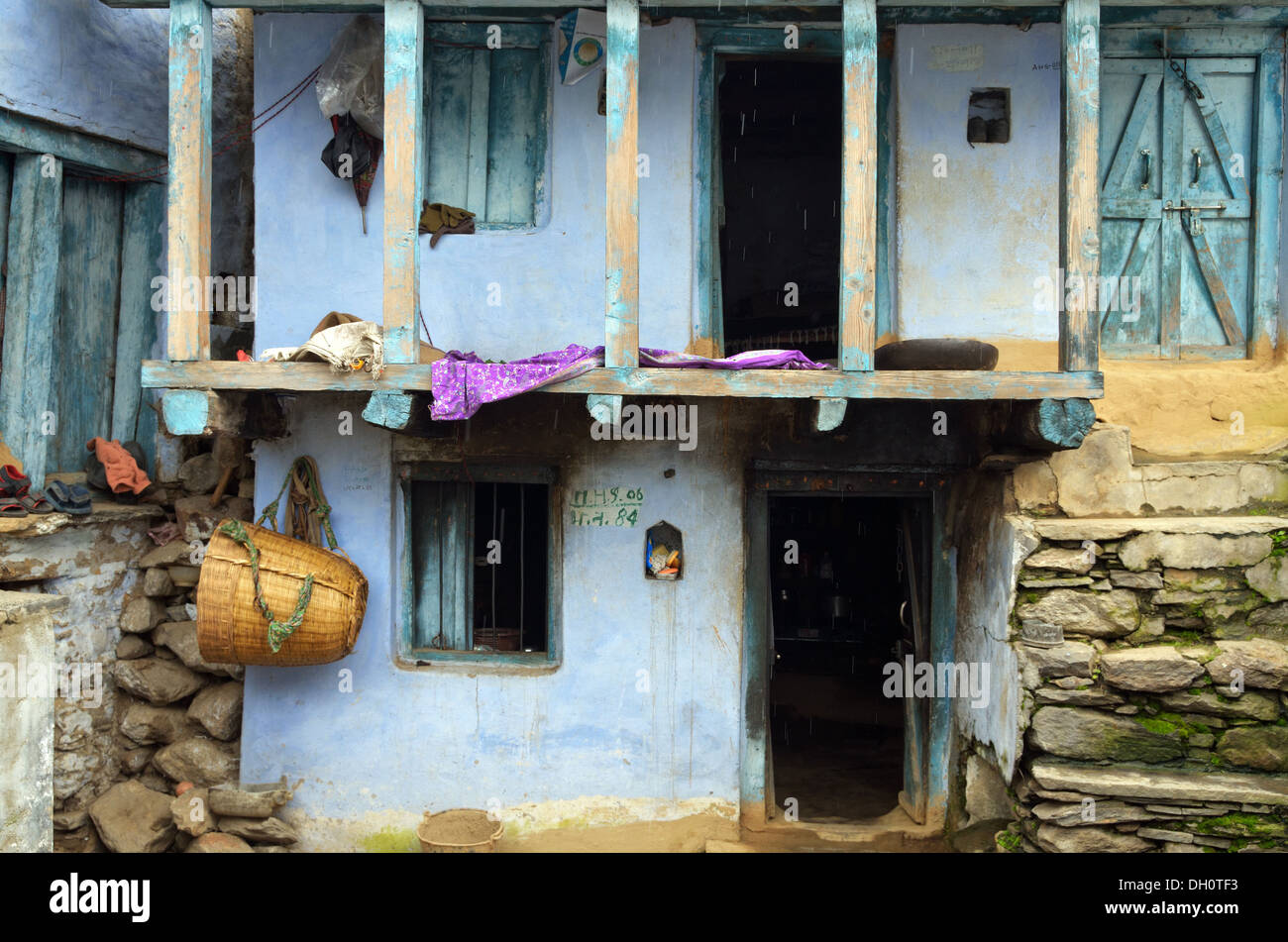 Blue home with basket hanging on the wall, Mana village, India Stock Photo