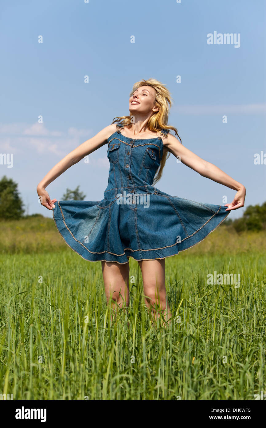 young woman in the field of green ears Stock Photo