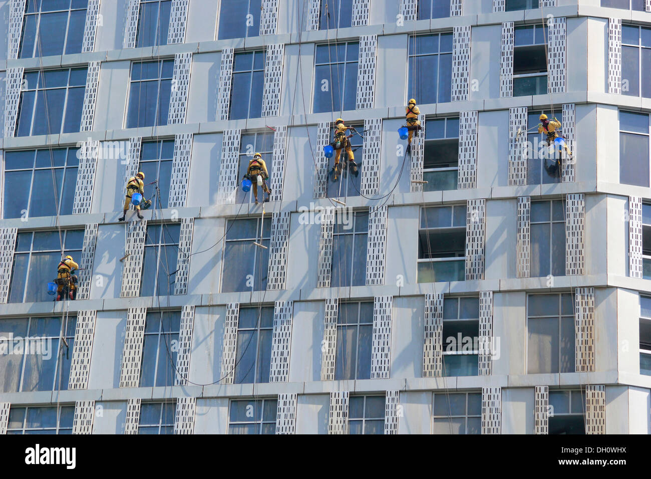 Window cleaners working on the façade of a skyscraper, Dubai Marina