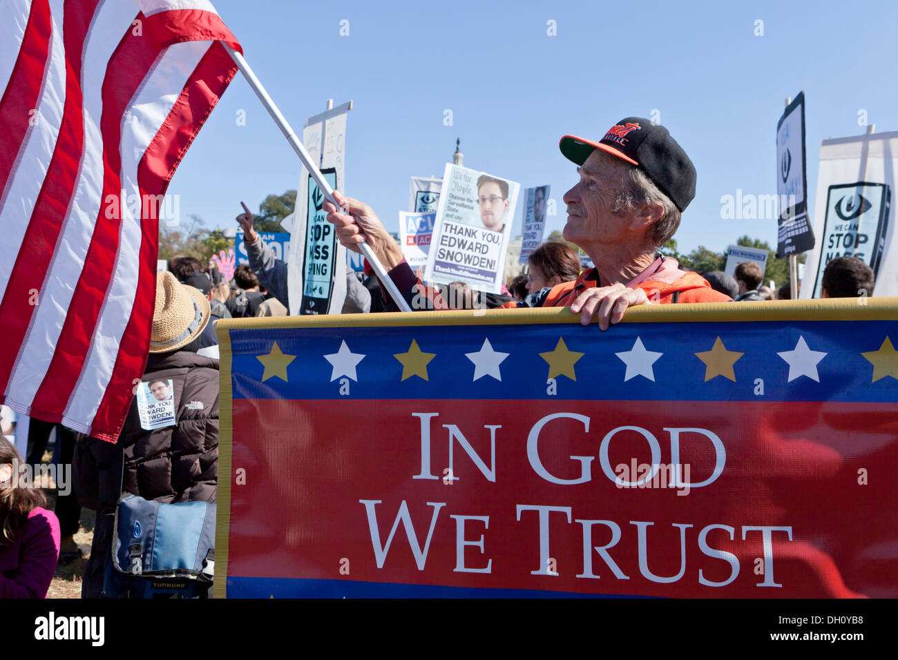 Man holding In God We Trust banner in NSA spying protest rally - Washington, DC USA Stock Photo