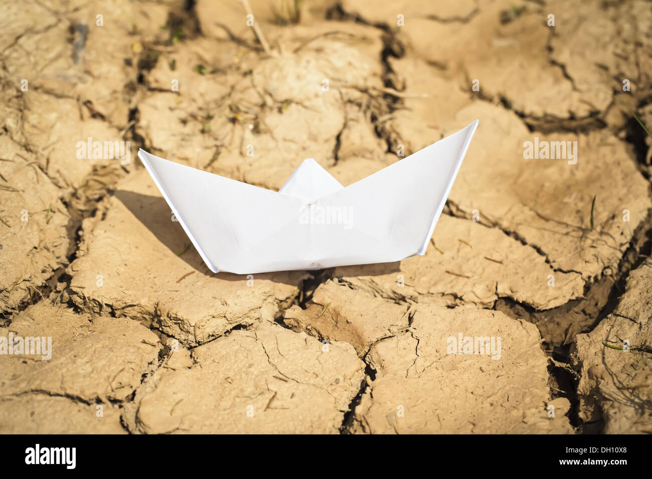 Paper boat on dry land Stock Photo