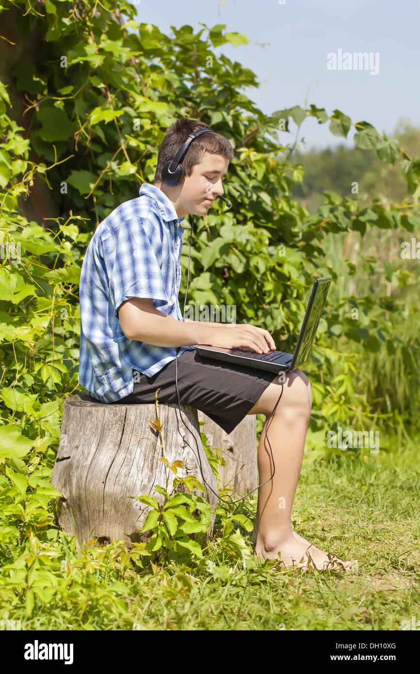 Boy with headphones, Mic and PC Stock Photo