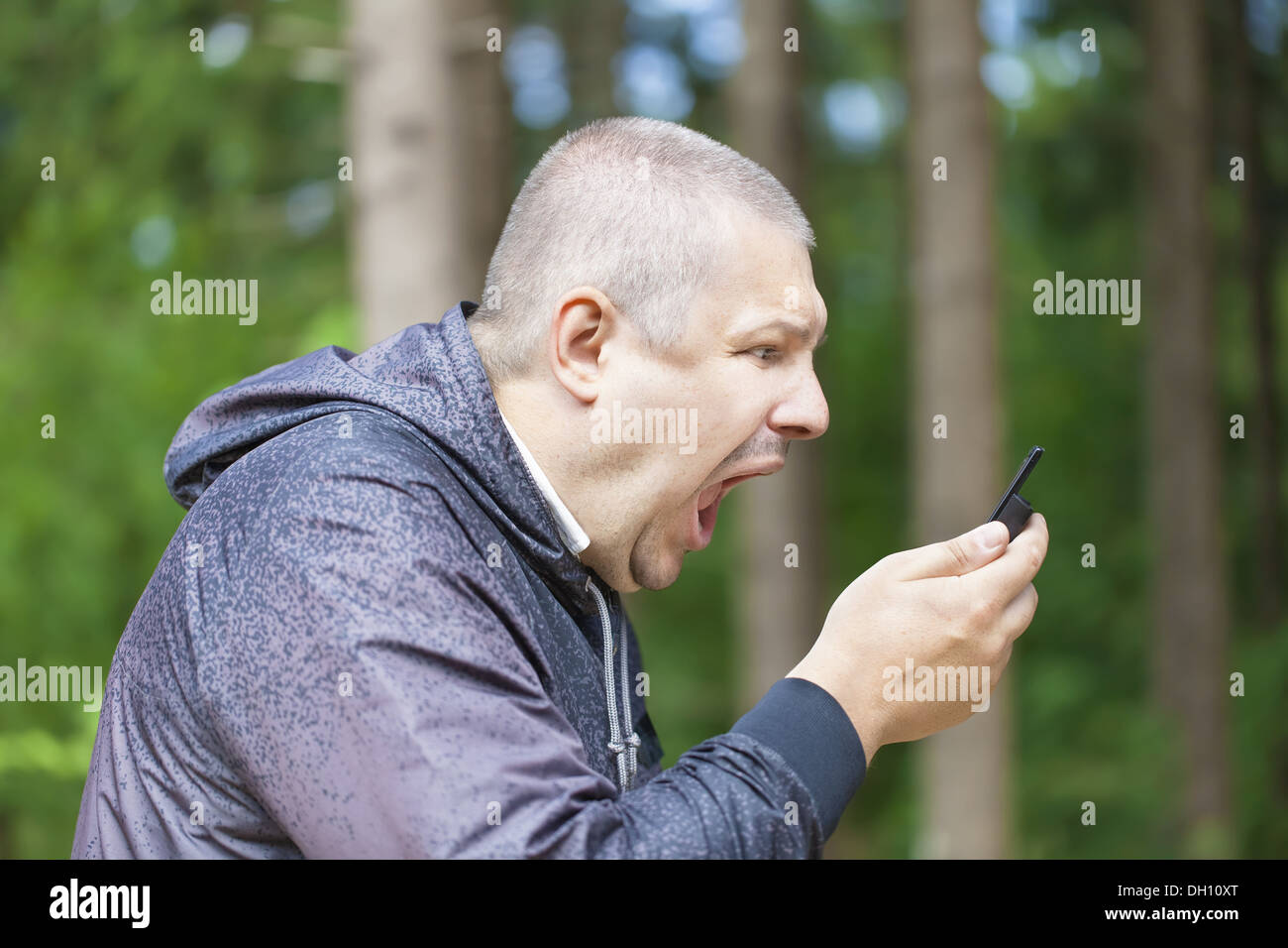 Man menacingly screaming at the phone Stock Photo