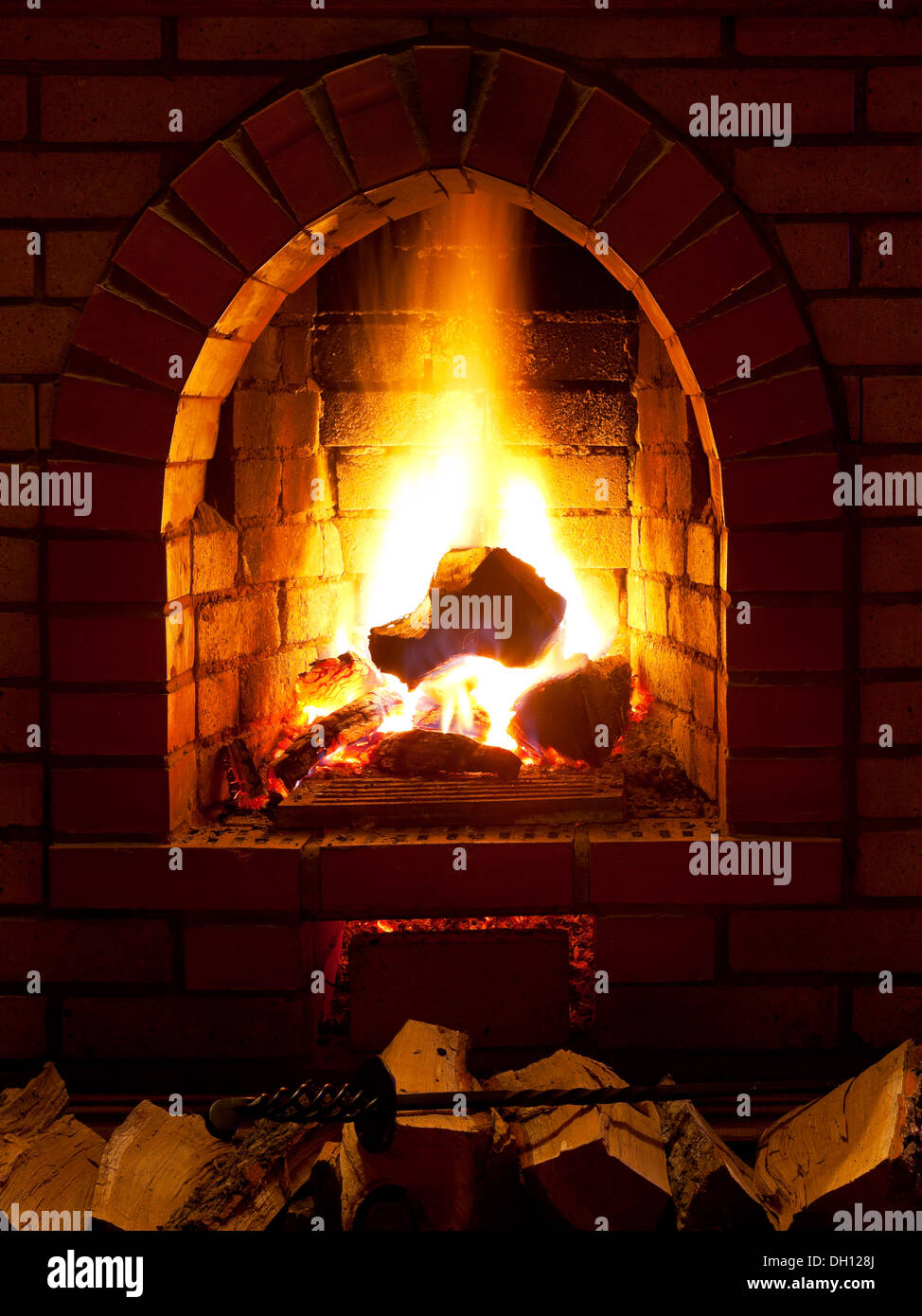 flames of fire in fireplace in evening time Stock Photo