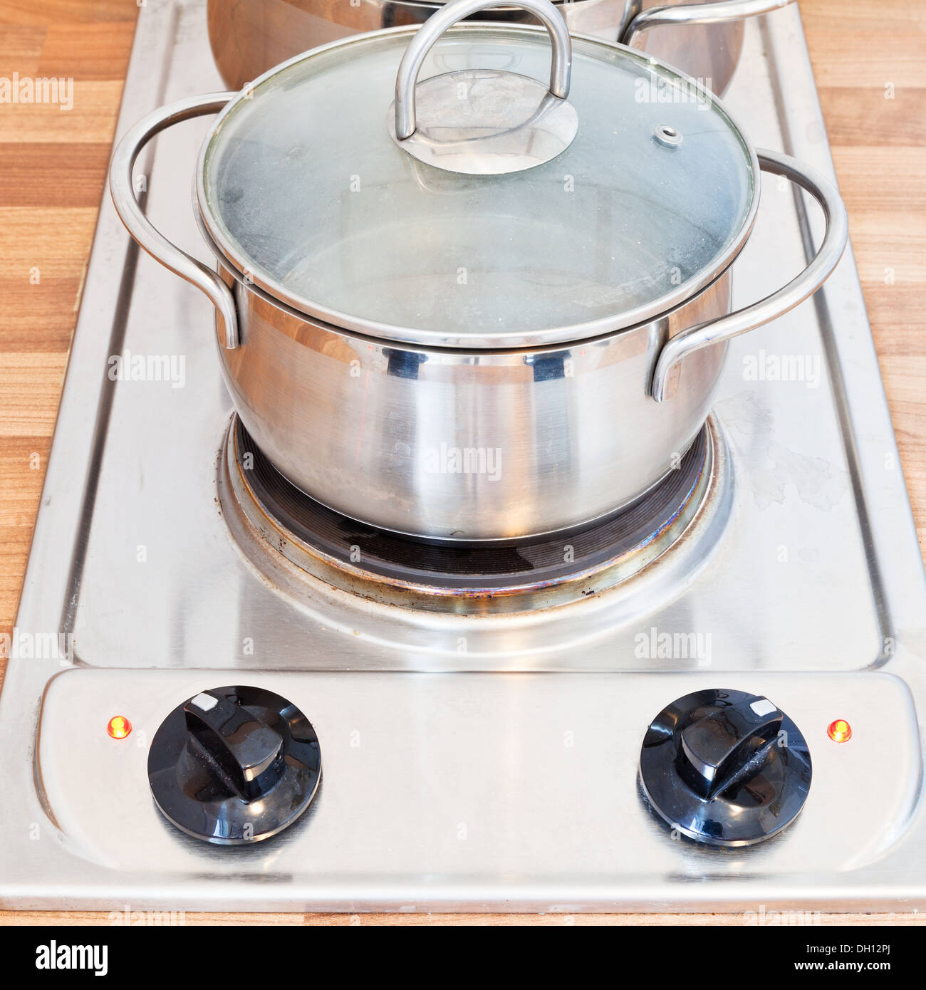 boiling water in metal pot on hotplate electric stove Stock Photo
