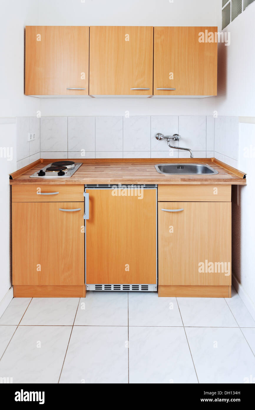 https://c8.alamy.com/comp/DH134H/small-kitchen-with-simple-furniture-set-DH134H.jpg
