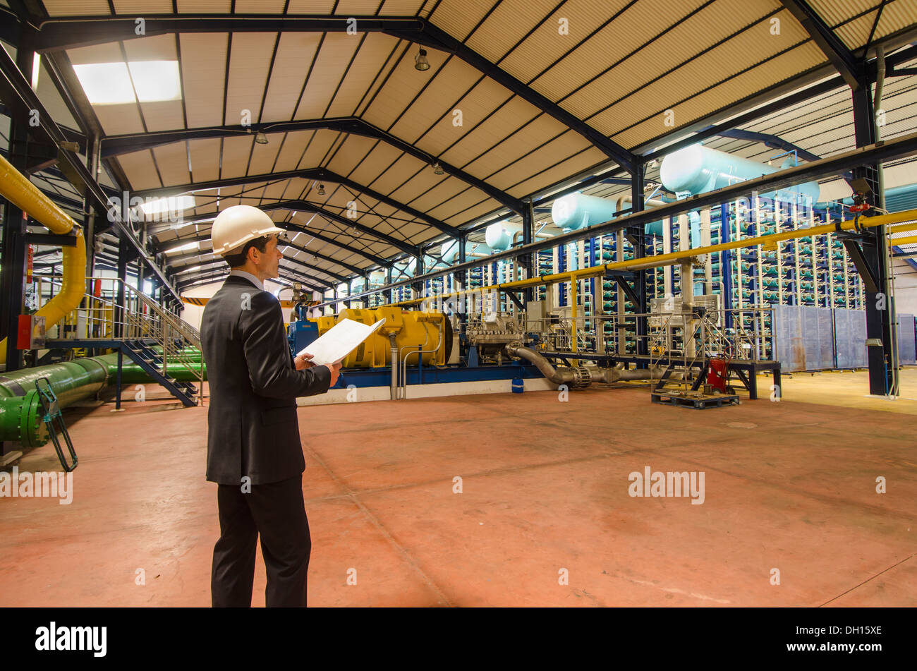 Hispanic businessman checking machinery Stock Photo