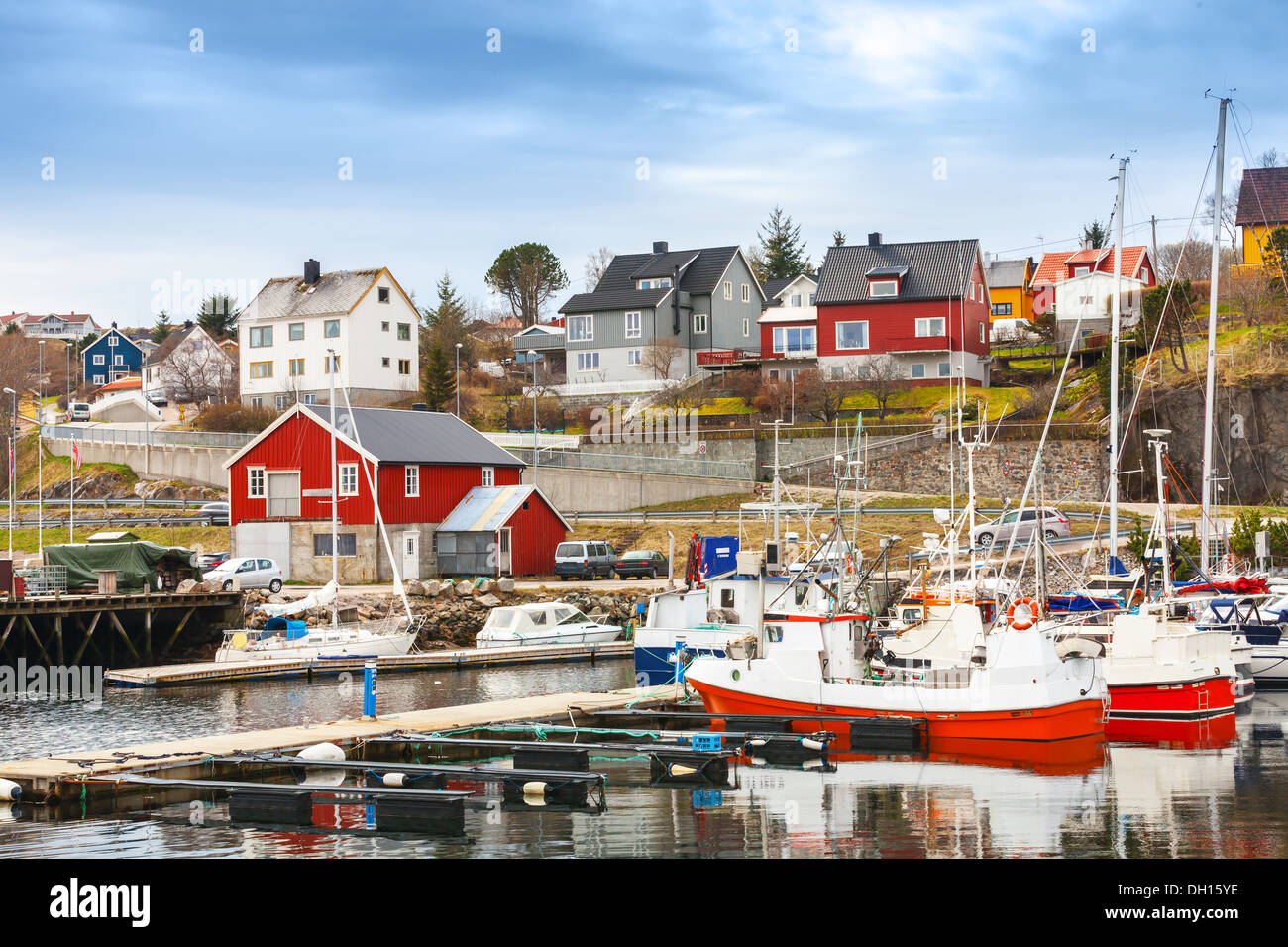 Small red and white fishing boats stand moored in Norway fishing town Rorvik Stock Photo