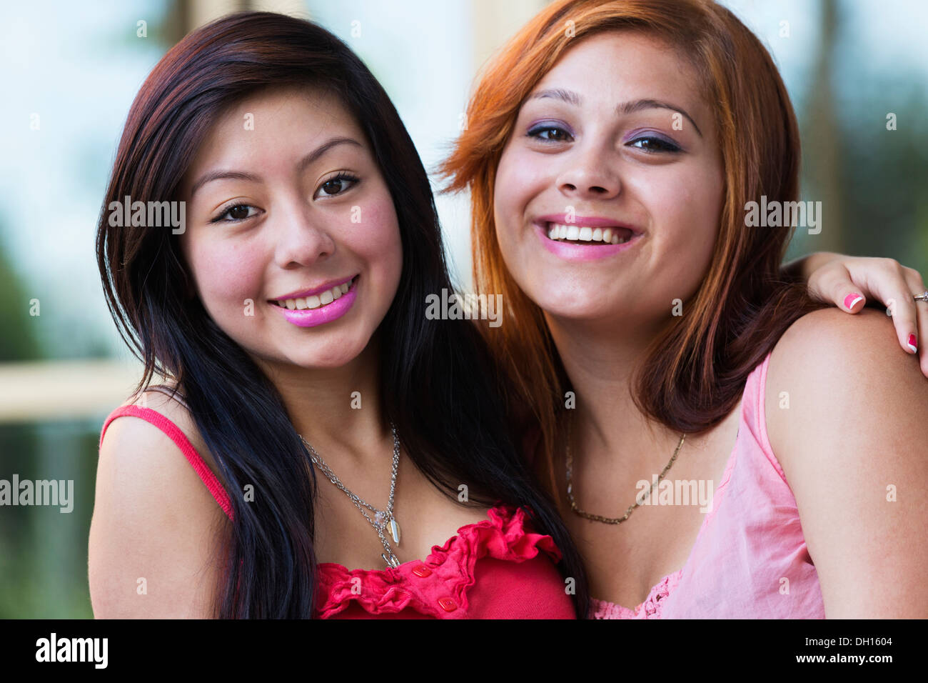 Hispanic girls smiling outdoors Stock Photo